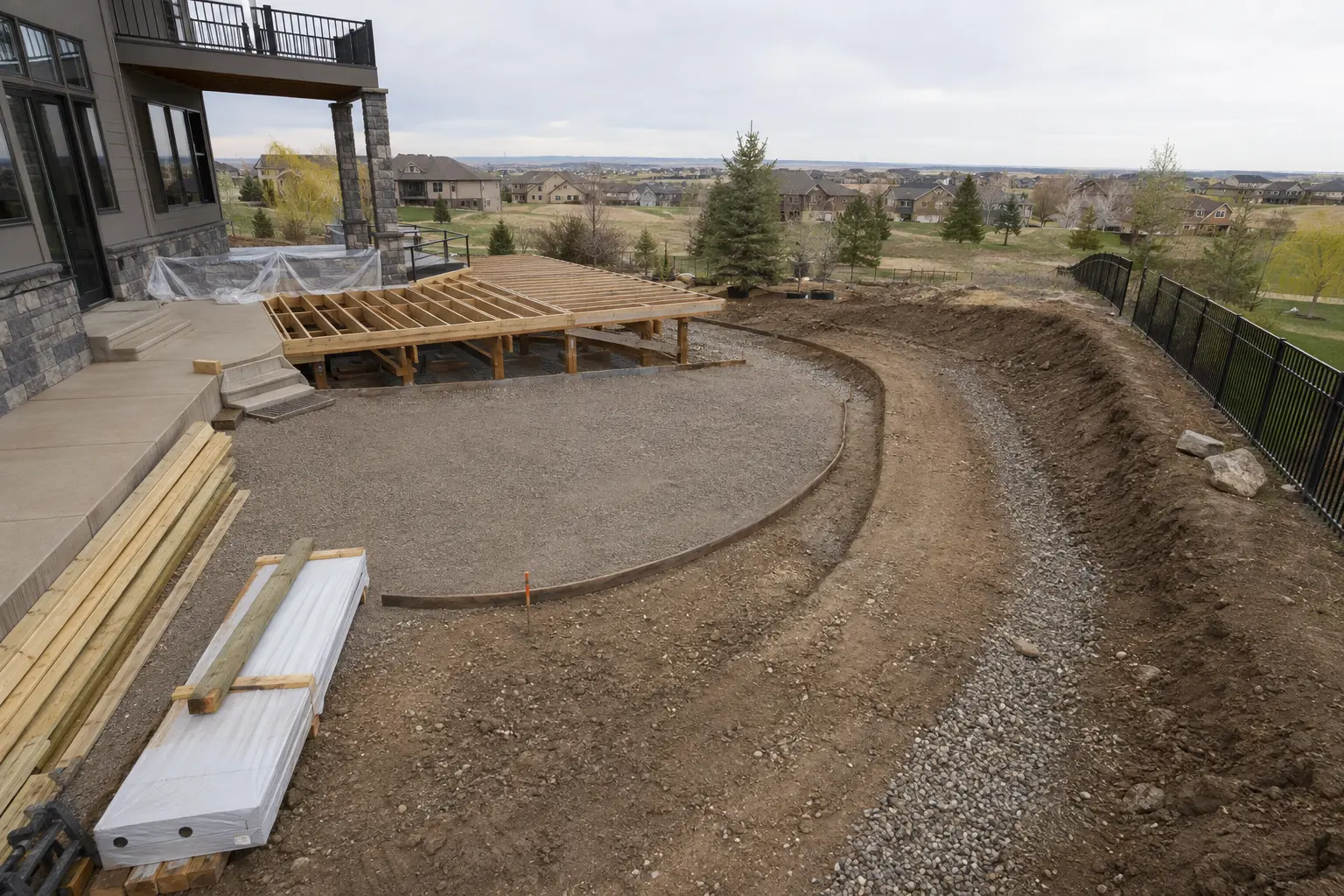 Backyard transformation in progress with coordinated outdoor living construction