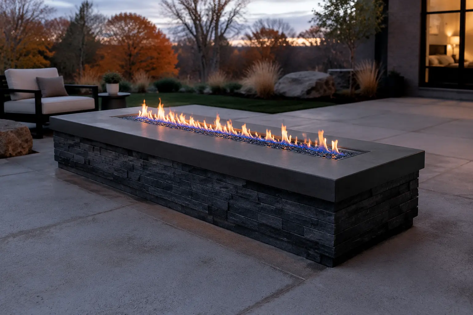 Linear gas fire feature with noncombustible stone and concrete surround and generous clearances